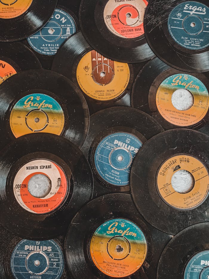 A nostalgic collection of vintage vinyl records displayed in a flat lay pattern.